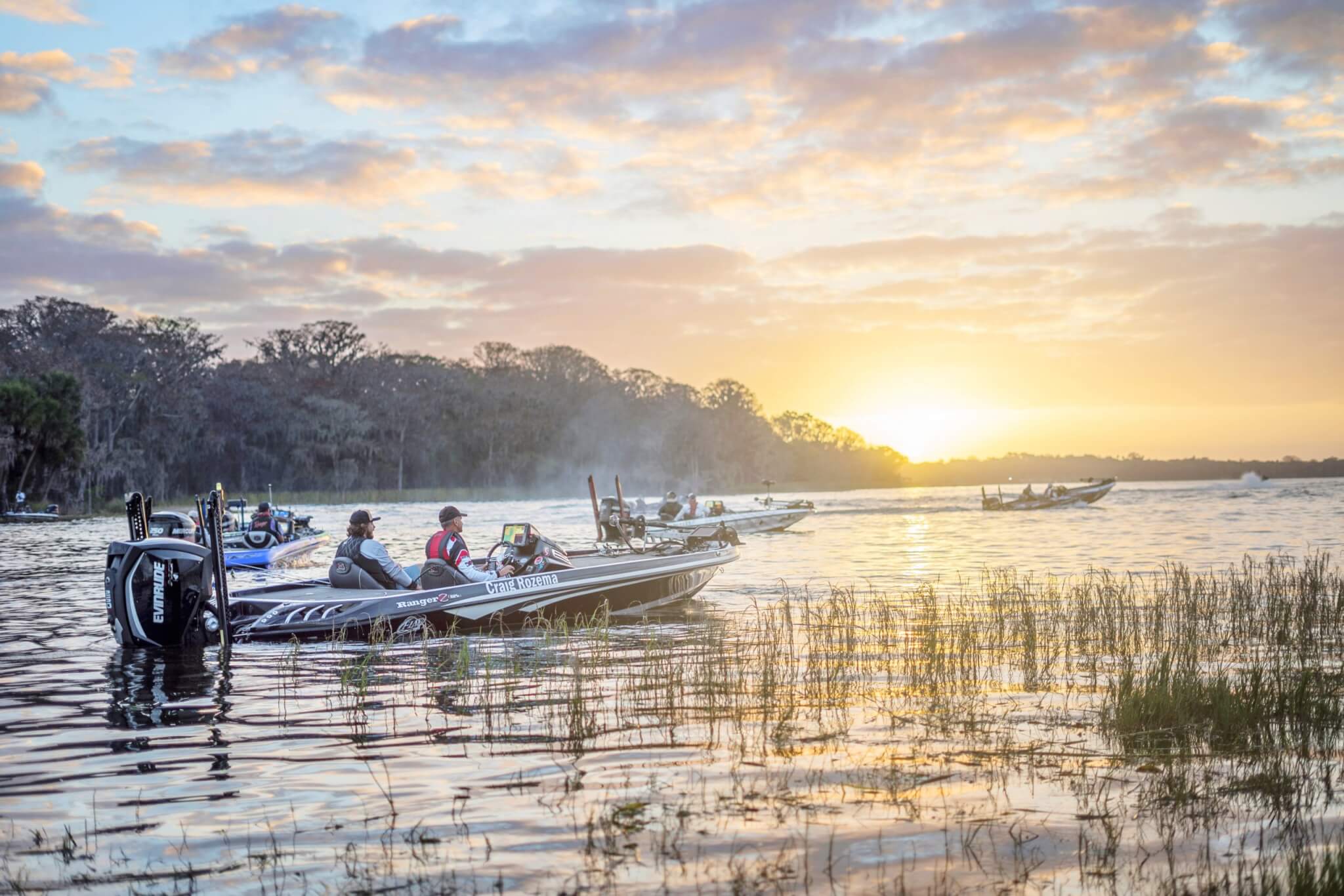 A fishing boat heads out on the Harris Chain of Lakes at dawn